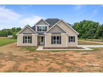 Charming two-story home features a symmetrical facade, complemented by black shutters and a well-manicured lawn at 4949 Rimer Rd # 4, Concord, NC 28025
