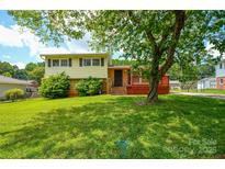 Charming two-story home with a well-maintained lawn and inviting front porch at 923 Yuma St, Charlotte, NC 28213