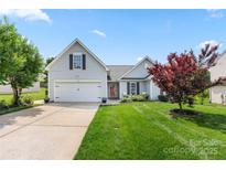 Beautiful home with a two-car garage, well-kept lawn, and mature landscaping in a suburban neighborhood at 114 Nevis Ln, Mooresville, NC 28115