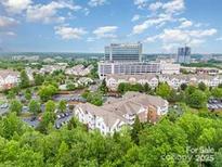 An aerial view of the condos and the commercial properties nearby offer a serene suburban skyline at 11530 Costigan Ln, Charlotte, NC 28277