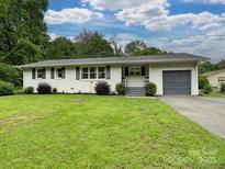 Charming one-story home with a well-maintained lawn, painted white brick and an attached garage at 136 Gable Rd, Mooresville, NC 28115