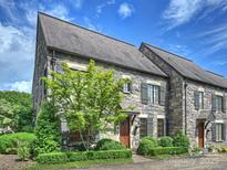 Charming stone townhome featuring beautiful landscaping and a private entrance at 1522 High St, Charlotte, NC 28211