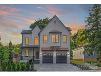 Beautiful two-story home with painted brick, copper accents, a covered porch, and a two-car garage at 2414 E 7Th St, Charlotte, NC 28204