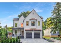 Stunning two-story home with brick facade, two-car garage, and mature trees at 2414 E 7Th St, Charlotte, NC 28204