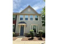 Charming townhouse with a gray exterior, complemented by landscaped bushes at 3039 Potomac River Pkwy, Charlotte, NC 28217