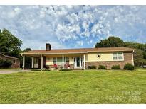 Charming single-story home with a covered front porch and well-maintained lawn at 403 Kings Dr, Cherryville, NC 28021