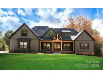 Charming home featuring an inviting front porch, neutral siding, and well-manicured lawn at 5016 Carolina North Dr, Gastonia, NC 28056
