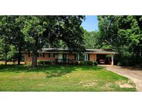 Charming brick ranch home featuring a covered carport, manicured lawn, and mature trees at 536 Catalina Dr, Albemarle, NC 28001