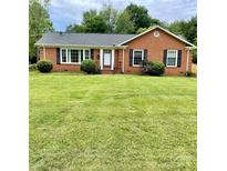 Charming brick home with a lush green lawn and well-maintained landscaping at 5734 Brookhaven Rd, Charlotte, NC 28210