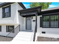 Inviting front entrance featuring a painted door, covered entry, and freshly painted steps at 6328 Beecher Dr, Charlotte, NC 28215