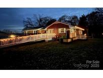 Charming single-story home with a brick exterior and a welcoming ramp decorated with string lights at 800 Charles Rd, Shelby, NC 28150