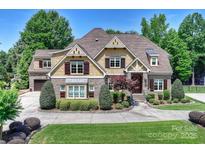 Charming home features a brick and siding exterior, manicured landscaping, and a welcoming front entrance at 9104 Kingsmead Ln, Waxhaw, NC 28173