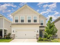 Charming two-story home with a two-car garage, well-maintained lawn, and beautiful curb appeal under a bright, sunny sky at 16018 River Tree Ln, Charlotte, NC 28278