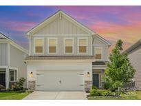 Charming two-story home with neutral siding, manicured lawn, and inviting curb appeal at sunset at 16018 River Tree Ln, Charlotte, NC 28278