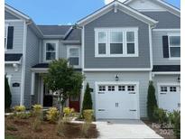 Charming two-story townhome with gray siding and a two-car garage, complemented by a well-maintained lawn at 216 Laura Elizabeth Ln, Clover, SC 29710