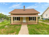 Charming one-story house with a covered front porch and well-maintained lawn at 217 S Highland St, Gastonia, NC 28052