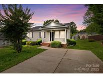 Charming single-story home with a well-manicured lawn, cozy front porch, and inviting curb appeal at 252 Sweet Bay Nw Ln, Concord, NC 28027