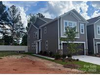 Charming two-story home with gray siding, inviting curb appeal, and attached garage at 304 Laura Elizabeth Ln, Clover, SC 29710