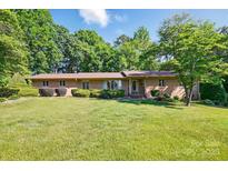 Charming brick home with a well-manicured lawn and mature landscaping at 308 Odell St, Kannapolis, NC 28083