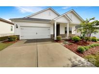Charming home featuring a two-car garage and a welcoming front porch, complemented by fresh landscaping at 4026 Honey Locust Dr, Charlotte, NC 28215