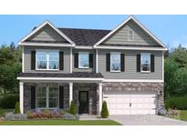 Charming two-story home with stone accents and a well-manicured lawn exudes curb appeal at 423 Balboa St, Matthews, NC 28104