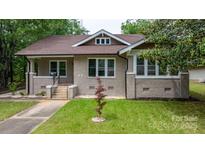 Charming single-story home featuring a brick facade, landscaped yard, and inviting front porch at 425 1St Se Ave, Hickory, NC 28602
