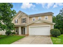 Charming two-story home with a two-car garage and well-maintained lawn at 512 Nanny Point Dr, Monroe, NC 28110