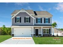 Charming two-story home with gray siding, black shutters, and a pristine front lawn at 518 Hullview Vista Vis # 15, Monroe, NC 28110