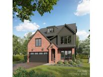 New construction home featuring a brick and dark siding exterior, complemented by manicured landscaping and a paved driveway at 713 Bertonley Ave, Charlotte, NC 28211