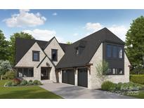 Elegant home exterior featuring a light brick facade, dark trim, and a three-car garage at 7215 Alexander Rd # 4, Charlotte, NC 28270