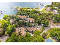 Stunning aerial view of 753 Southwest Drive in a lakeside community with a pool, tennis court, and marina at 753 Southwest Dr, Davidson, NC 28036
