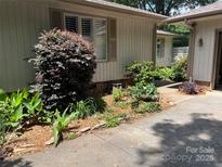 Charming exterior featuring well-maintained landscaping and a cozy garden area at 8 Sunrise Point Rd, Lake Wylie, SC 29710