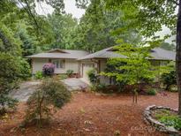 Charming single-story home with a well-maintained lawn and mature trees offering ample shade and curb appeal at 8 Sunrise Point Rd, Lake Wylie, SC 29710