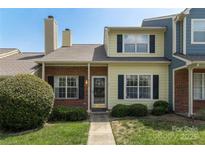 Charming townhouse featuring a brick and siding facade with a well-manicured lawn and inviting entrance at 9006 Four Mile Creek Rd, Charlotte, NC 28277