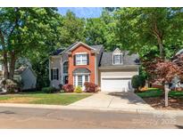 Charming two-story home with brick and siding exterior and attached two car garage at 10419 Chelsea Bay Dr, Charlotte, NC 28278