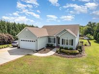 Charming single story home with well manicured lawn, attached garage, and driveway at 115 Meadow Lake Dr, Salisbury, NC 28146