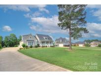 Beautiful home with lush lawn, mature trees, and a long driveway creating attractive curb appeal at 1327 Springlake Rd, York, SC 29745