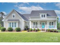 Charming single-Gathering home featuring a welcoming front porch and a vibrant turquoise front door at 1327 Springlake Rd, York, SC 29745