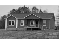 Charming single-story home with a welcoming front porch and gray siding at 140 Silvermere Dr, Statesville, NC 28625