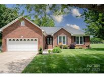 Charming brick home with a well-maintained lawn, attached garage and manicured landscaping at 150 Wordsworth Way, Mooresville, NC 28115