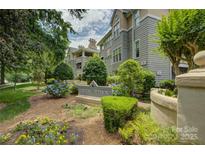 Charming condo community entrance with lush landscaping and well-maintained buildings at 226 Queens Rd # 68, Charlotte, NC 28204
