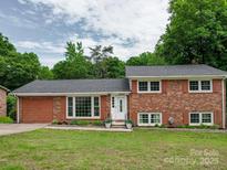 Charming brick two-story home with landscaped yard and a welcoming white front door, offering great curb appeal at 2666 Hill Ln, Gastonia, NC 28054