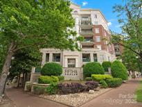 Beautiful Fifth and Poplar Condominiums building featuring brick, a manicured lawn, and inviting entrance in Charlotte NC at 300 W 5Th St # 433, Charlotte, NC 28202