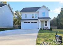 Charming two-story home with a well-maintained lawn, two car garage and welcoming front porch at 320 Lawrence Gray Rd, Charlotte, NC 28262