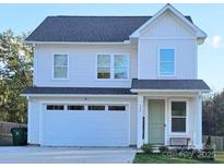 Charming two-story home with a white facade, attached garage, and well-maintained landscaping at 320 Lawrence Gray Rd, Charlotte, NC 28262