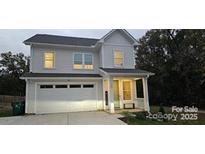 Charming two-story home features a white exterior, attached garage, and well-maintained landscaping at 320 Lawrence Gray Rd, Charlotte, NC 28262