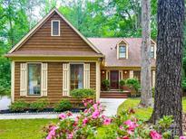 Charming home with wood siding, manicured landscaping, and inviting front entrance at 3214 Tilley Morris Rd, Matthews, NC 28105