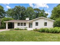 Charming brick home featuring a well-manicured lawn and lovely landscaping at 4017 Sulkirk Rd, Charlotte, NC 28210