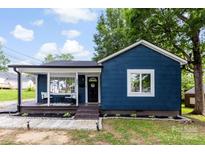 Charming single-story home featuring a welcoming front porch and a freshly landscaped yard at 403 W 2Nd St, Cherryville, NC 28021