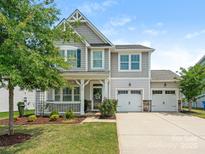 Charming two-story home with a well-manicured lawn, a welcoming porch, and a two-car garage at 4912 Grace View Dr, Pineville, NC 28134